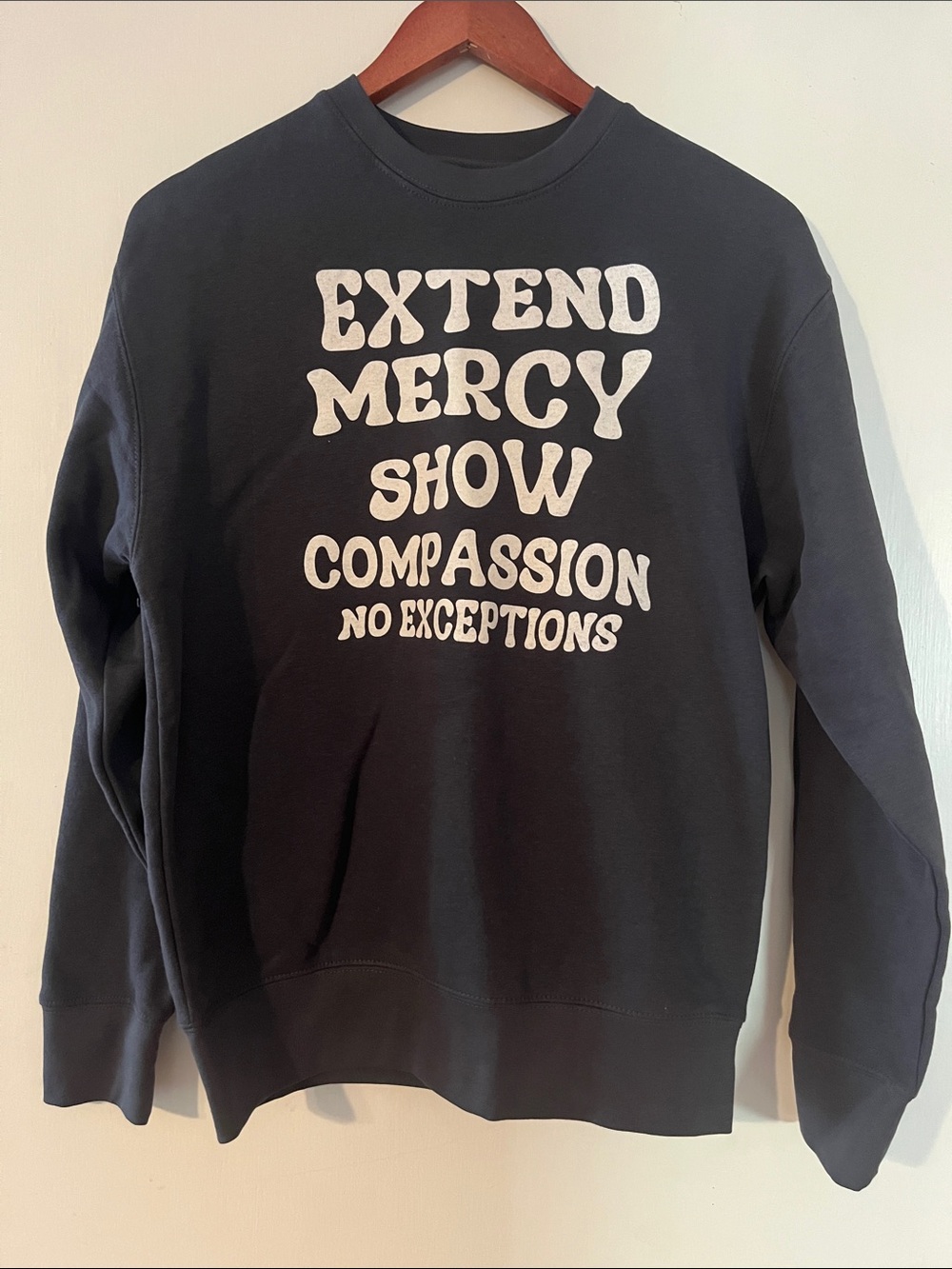 Women's Black Crewneck Sweatshirt with 'Extend Mercy Show Compassion' Slogan